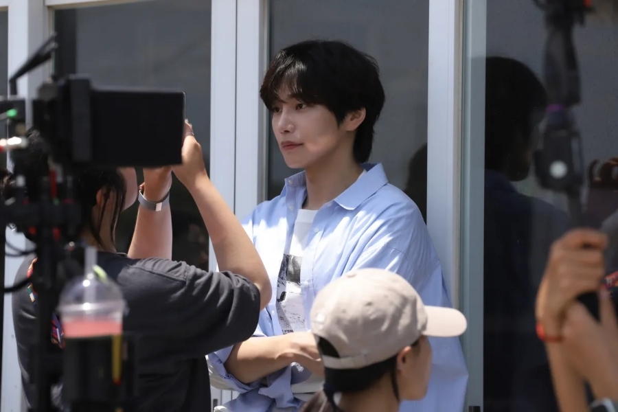 Kim Jae young Prepares for Scene with Focused Kim Jae-young with a serious expression while preparing for a scene during drama filming.